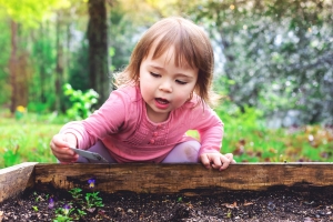 Happy toddler girl playing outside